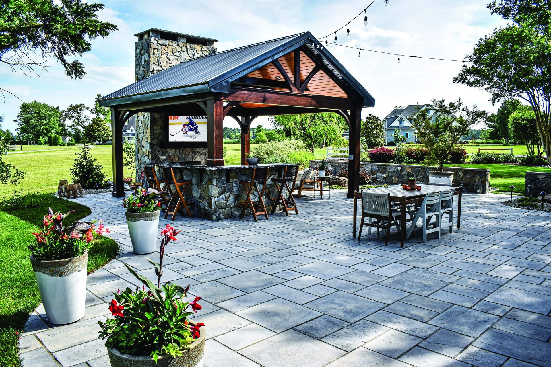 A patio area with a pavilion and tables and chairs