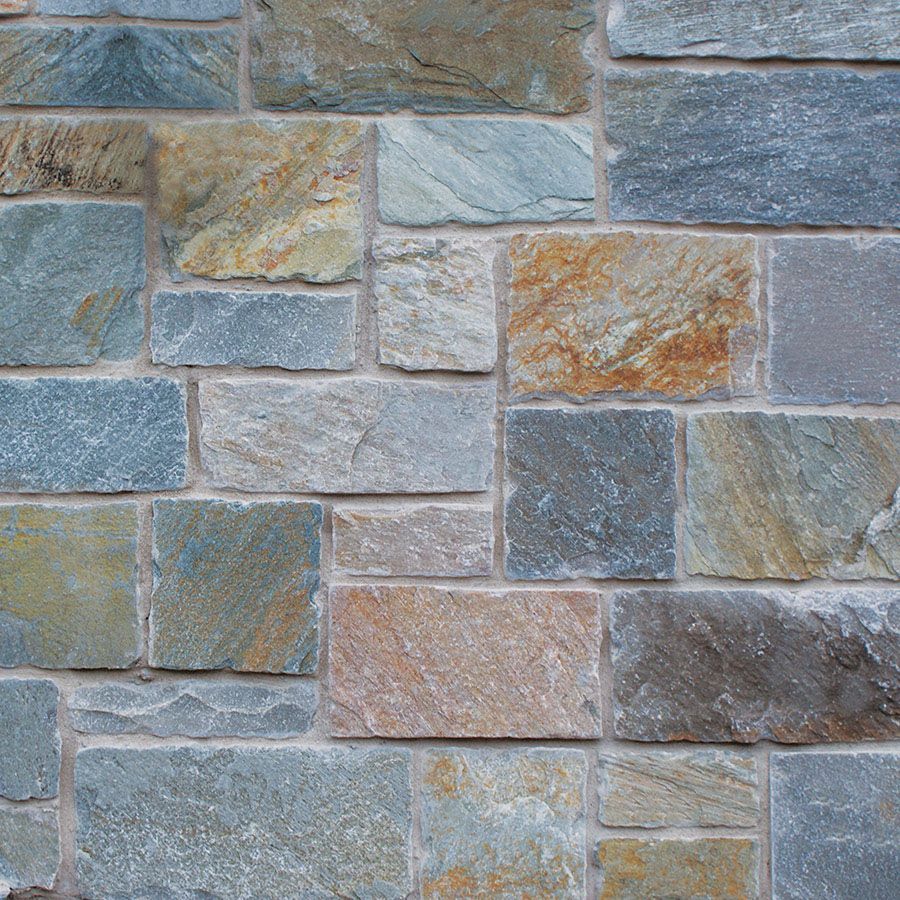 A brick wall with a lot of different colored bricks
