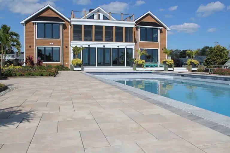 A large house with a swimming pool in front of it