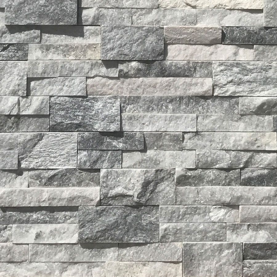 A close up of a gray and white brick wall.