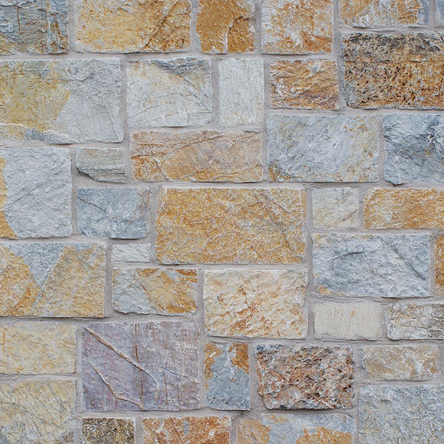 A brick wall with a lot of different colored bricks