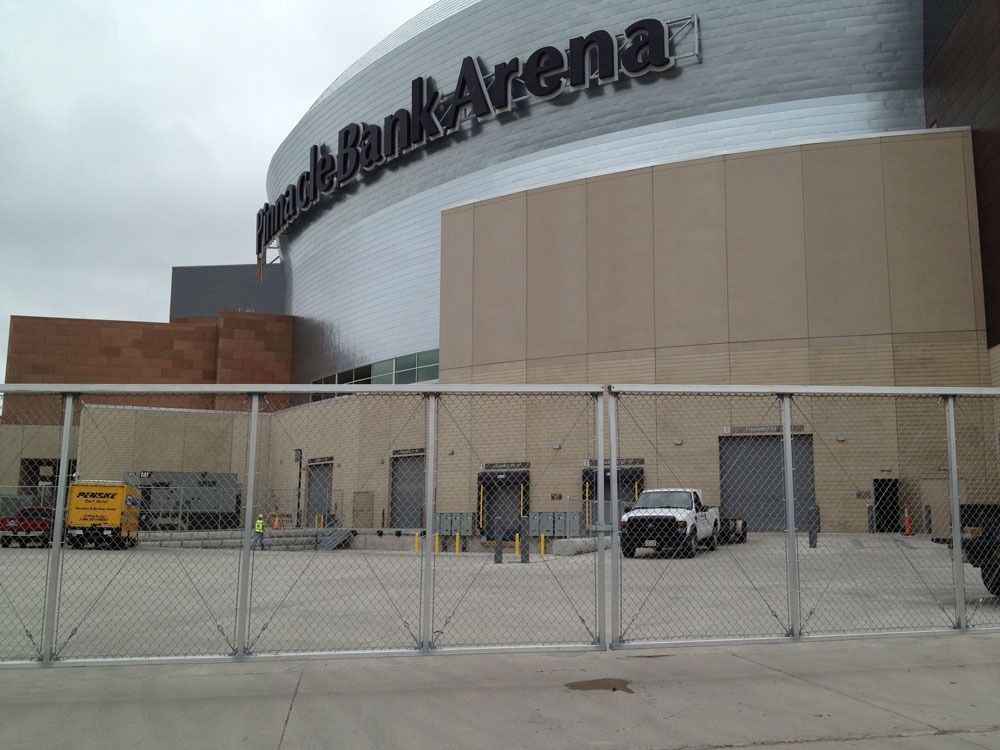 Fence in front of the T-Mobile Center building with loading docks.