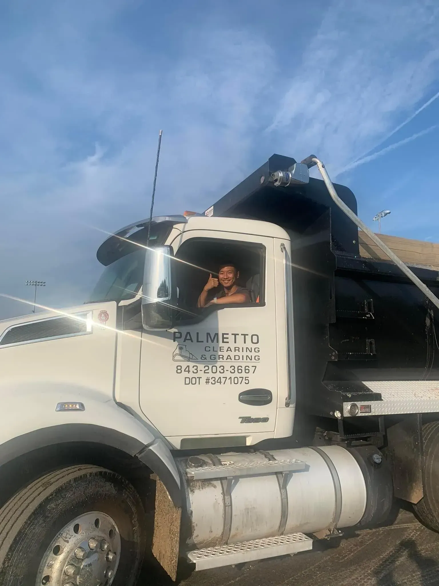 Man in white dump truck with 