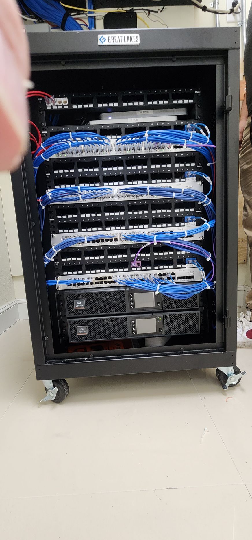 A server rack filled with lots of servers and wires