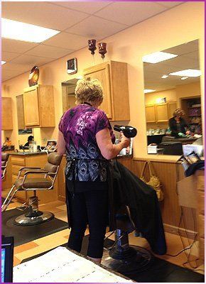 Stylist with a hair blower