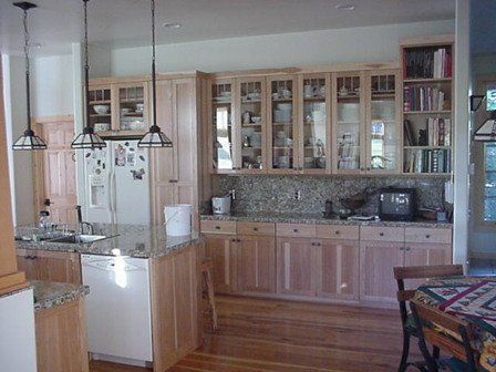 A kitchen with wooden cabinets and granite counter tops