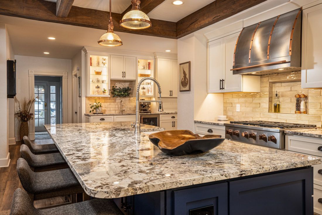 A kitchen with granite counter tops and stainless steel appliances.