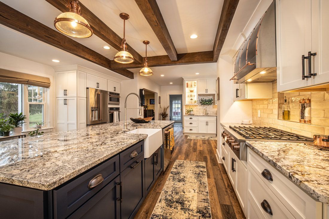 A kitchen with granite counter tops and stainless steel appliances.