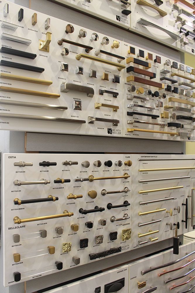 A wall filled with lots of different types of handles and knobs.