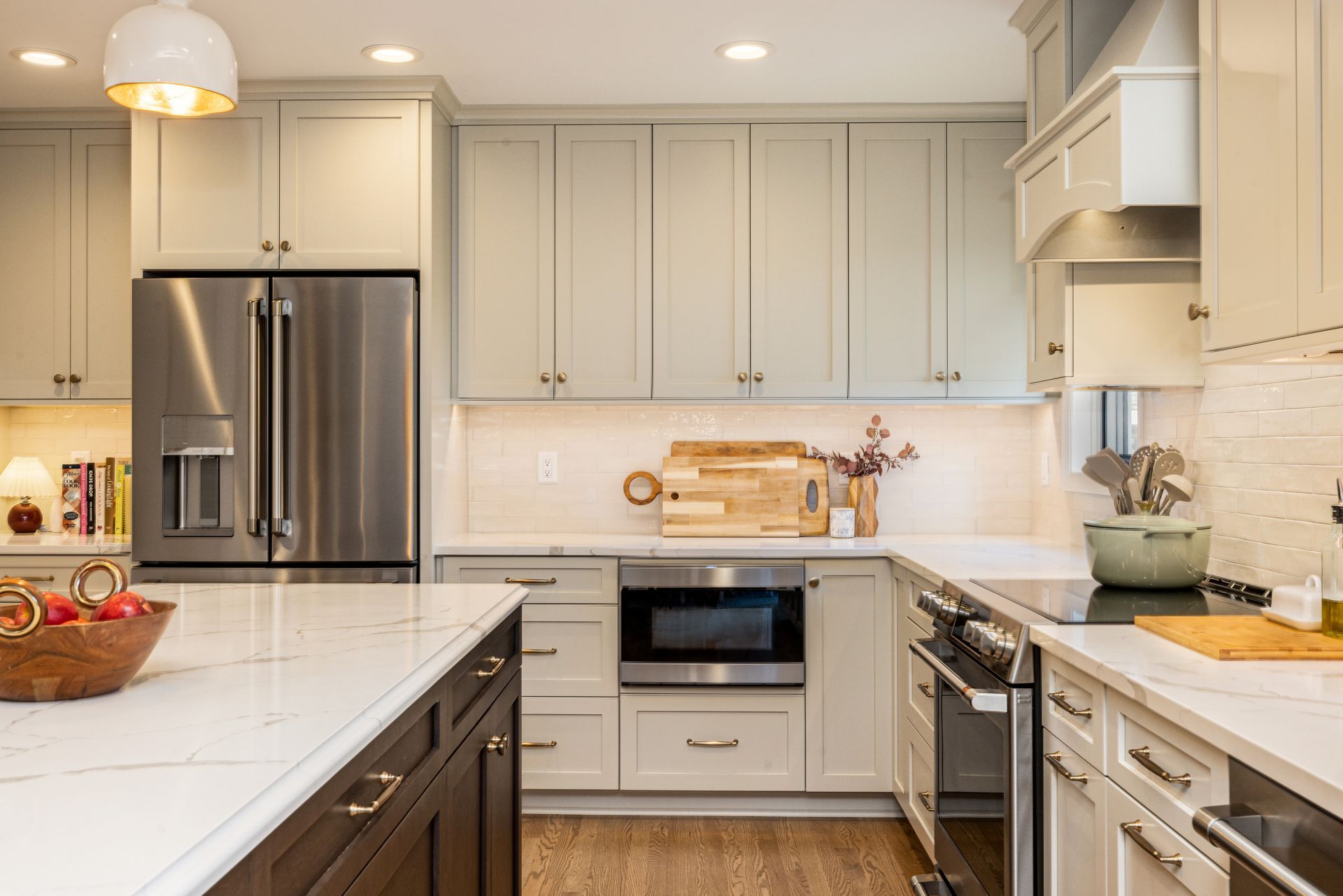 A kitchen with stainless steel appliances and white cabinets.