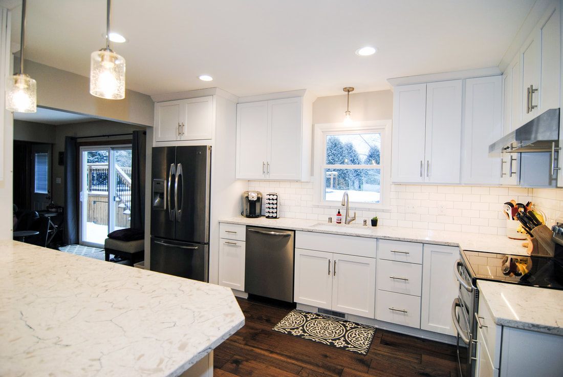 A kitchen with white cabinets and stainless steel appliances.