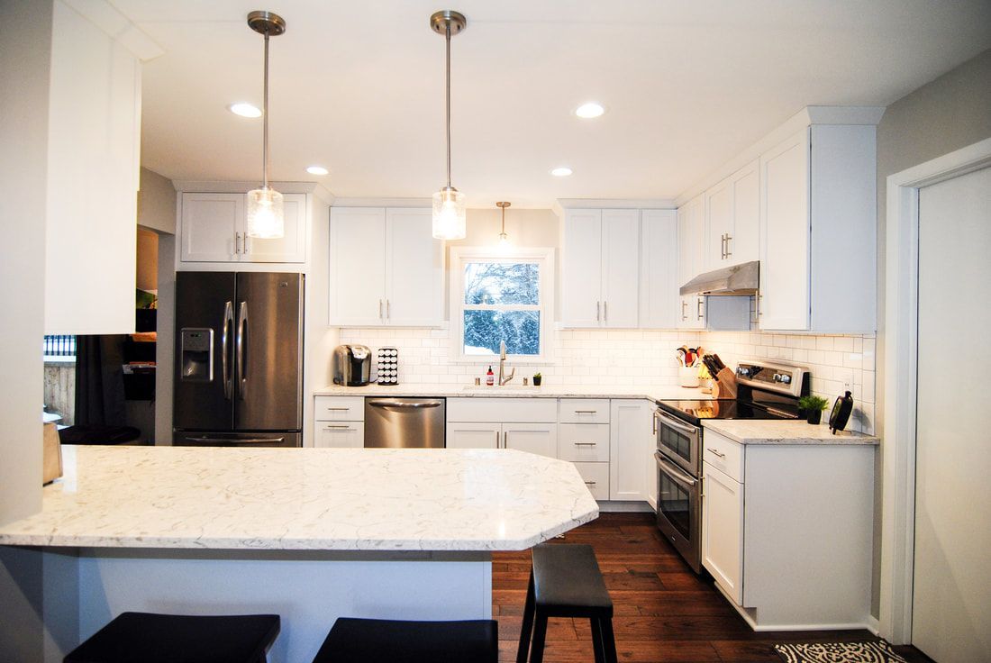 A kitchen with white cabinets and stainless steel appliances