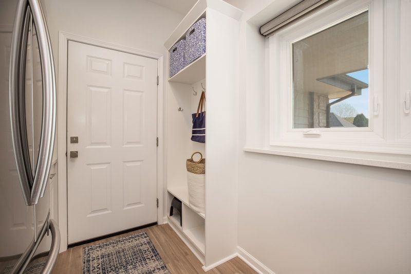 A laundry room with a washer and dryer and a window.
