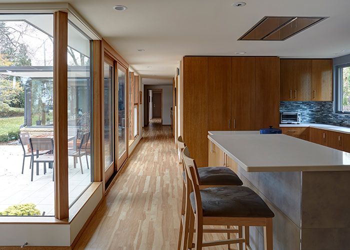 A kitchen with a long hallway leading to the backyard