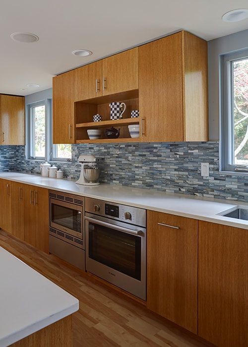 A kitchen with stainless steel appliances and wooden cabinets