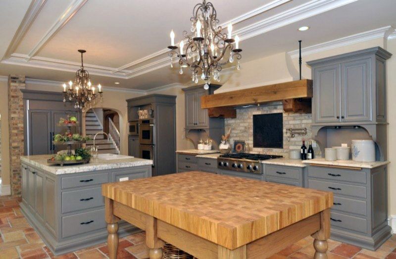 A kitchen with a large wooden table in the middle