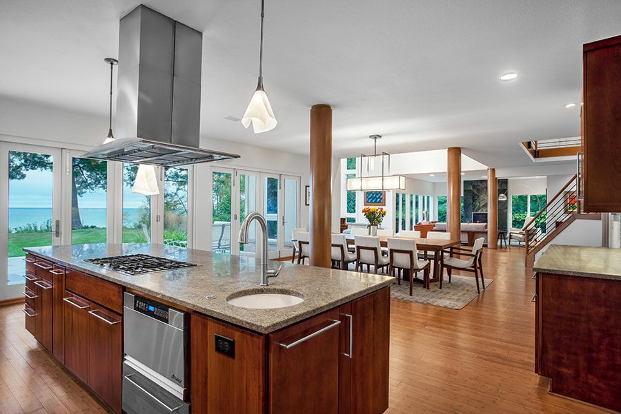 A kitchen with a large island and a stove top oven