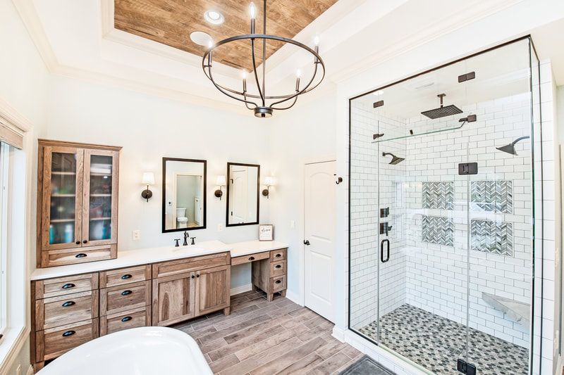 A bathroom with a walk in shower and a bathtub.