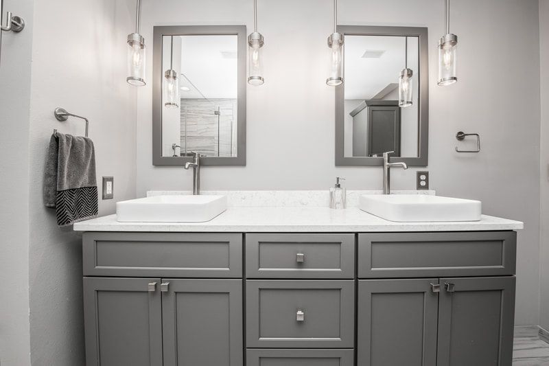A bathroom with two sinks and two mirrors.