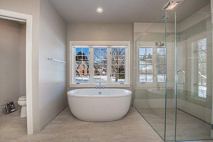 A bathroom with a tub and a walk in shower.