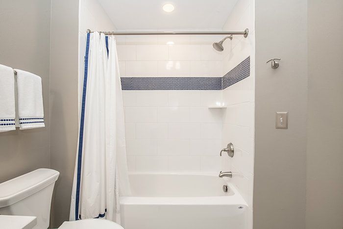 A bathroom with a toilet , bathtub and shower.