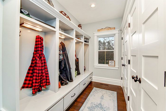 A hallway with a lot of shelves and a window.