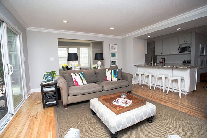 A living room with a couch , coffee table , and stools.
