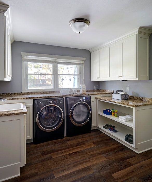 A laundry room with a washer and dryer and a sink.