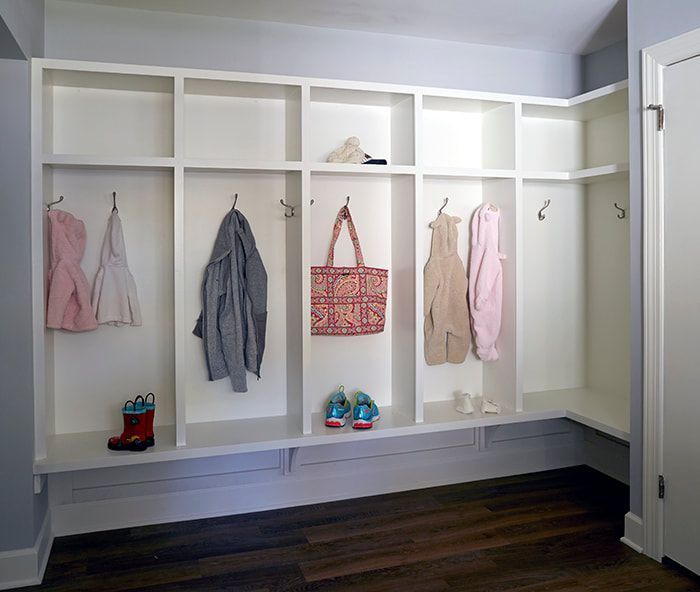 A room with a lot of shelves and hooks on the wall.