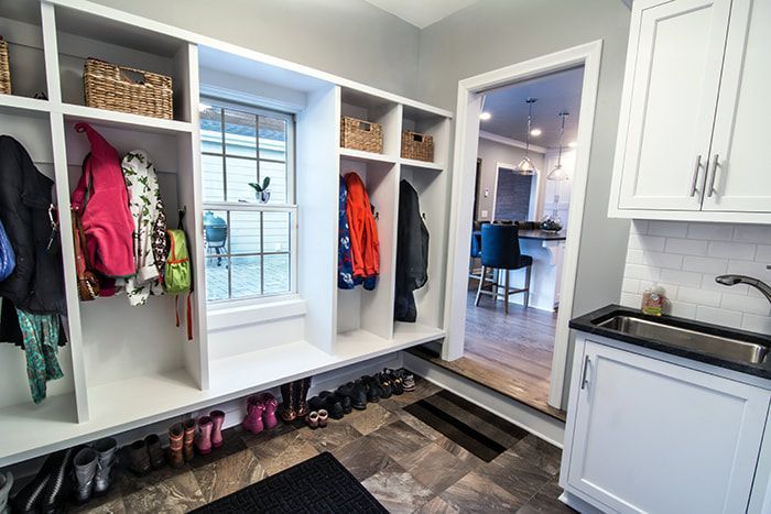 A mud room with a sink and a window.