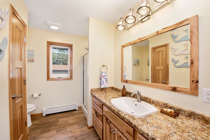 A bathroom with a sink , toilet , and mirror.