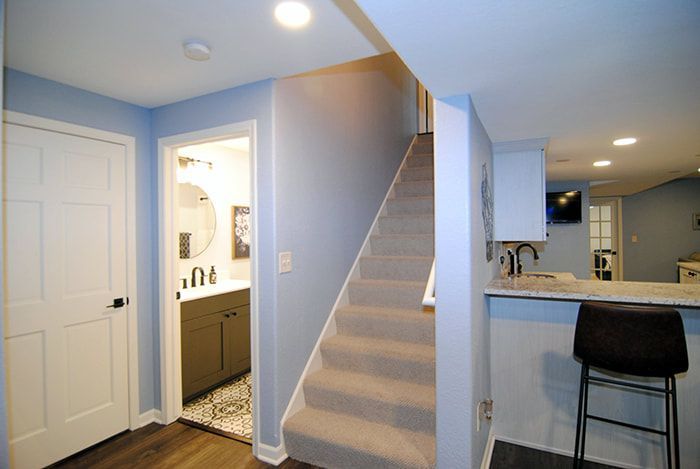 A hallway with stairs leading up to the second floor of a house.