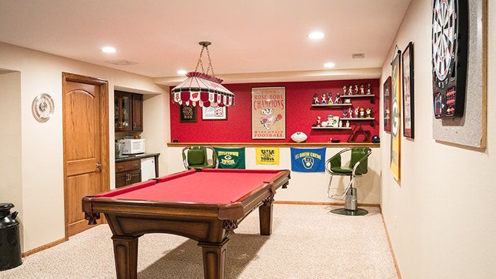 There is a pool table in the middle of the room.