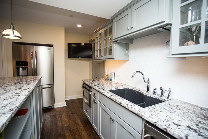A kitchen with granite counter tops and stainless steel appliances.