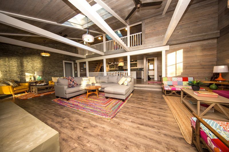 A living room filled with furniture and a ceiling fan.