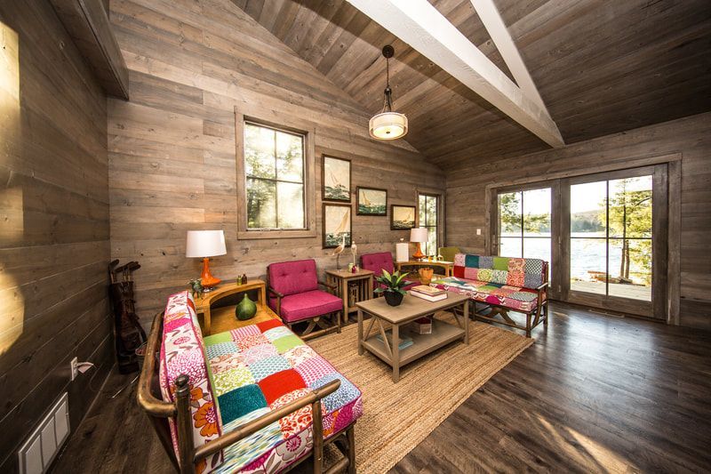 A living room with a couch , chairs , and a coffee table.