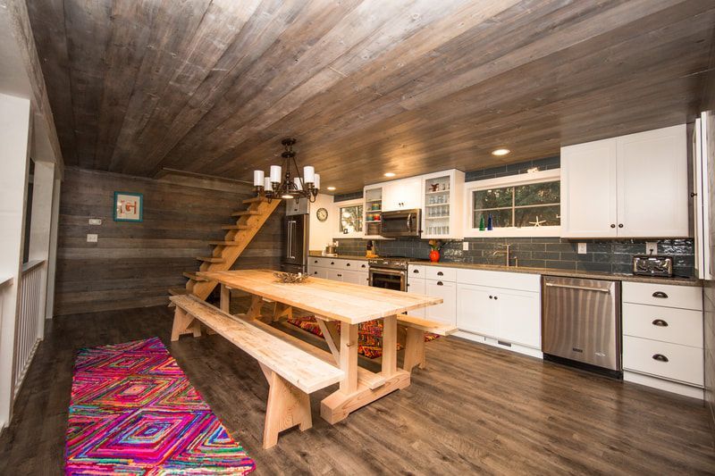 A kitchen with a large wooden table and benches.