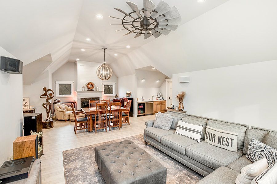 A living room filled with furniture and a ceiling fan.