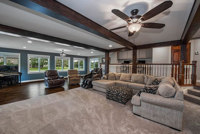 A living room filled with furniture and a ceiling fan.