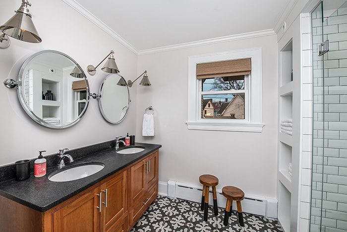 A bathroom with two sinks and two mirrors.