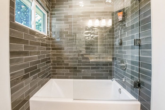 A bathroom with a bathtub and a walk in shower.