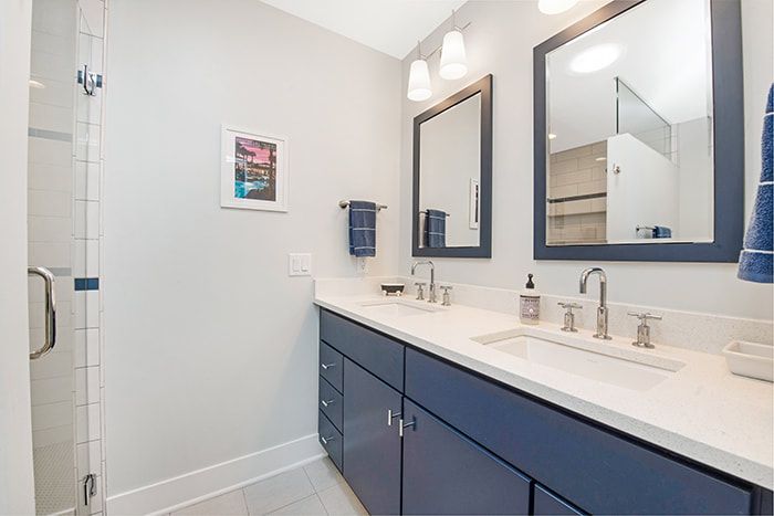 A bathroom with two sinks and two mirrors.
