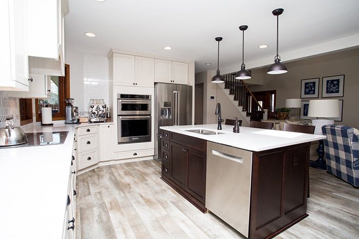 A kitchen with a large island and stainless steel appliances.