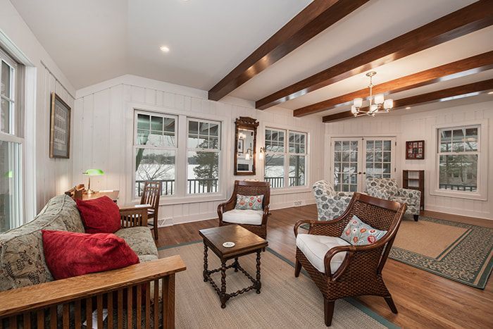 A living room with a couch , chairs , and a table.