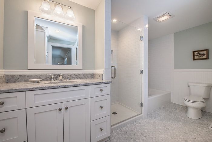 A bathroom with a sink , toilet , and shower.