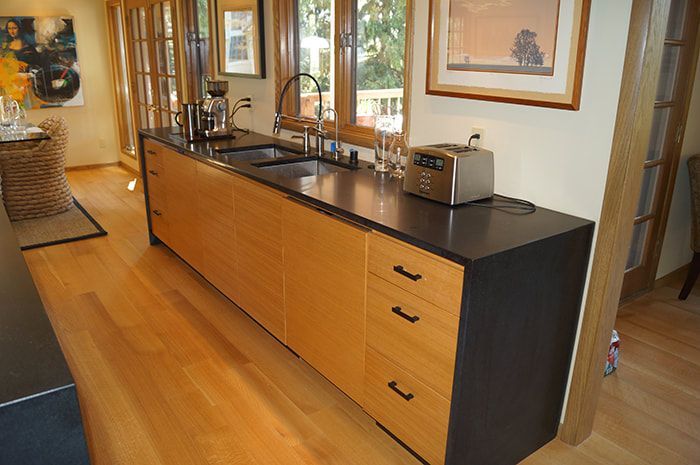 A kitchen with a sink and a toaster on the counter