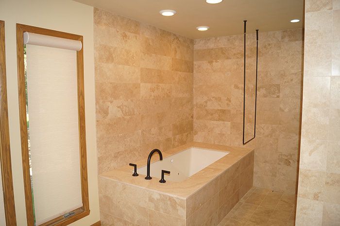 A bathroom with a tub and a shower.