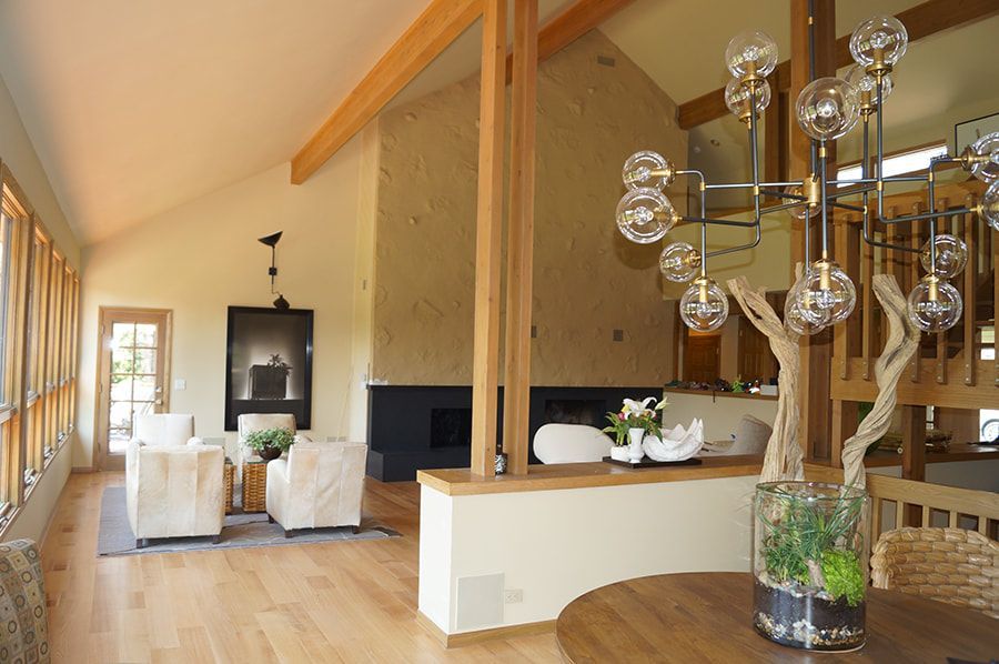 A living room with a table and chairs and a chandelier