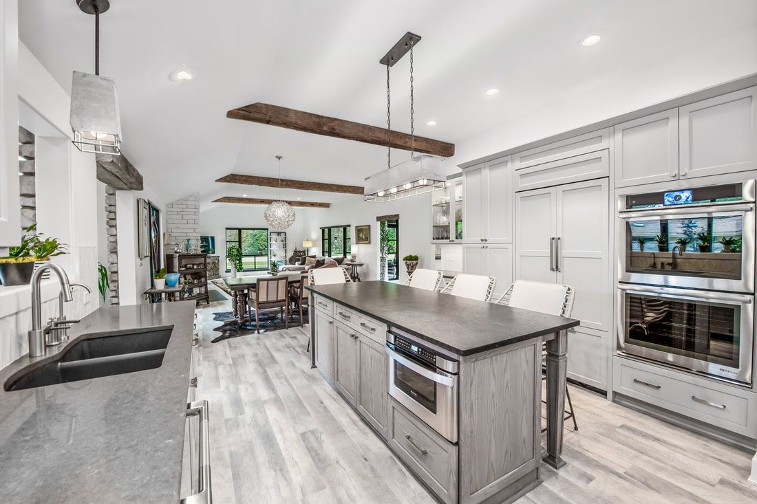 A kitchen with a large island and stainless steel appliances.