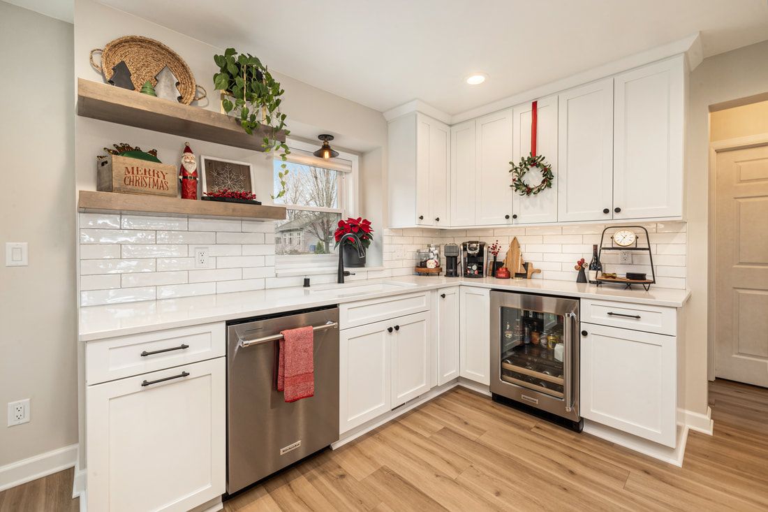 A kitchen with white cabinets and stainless steel appliances.